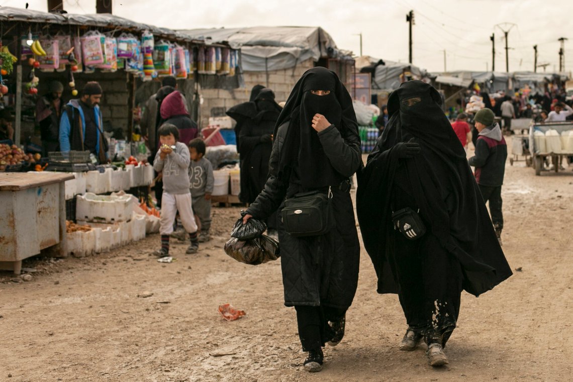 FILE - In this March 31, 2019 file, photo, women shop in the marketplace at al-Hol camp, home to families of Islamic State fighters, in Hasakeh province, Syria. Killings have surged inside the camp with at least 20 men and women killed in January, 2021. They are believed to be the victims of IS militants trying to enforce their power inside the camp housing 62,000 people, mostly women and children. (AP Photo/Maya Alleruzzo, File) FILE - In this March 31, 2019 file, photo, women shop in the marketplace at al-Hol camp, home to families of Islamic State fighters, in Hasakeh province, Syria. Killings have surged inside the camp with at least 20 men and women killed in January, 2021. They are believed to be the victims of IS militants trying to enforce their power inside the camp housing 62,000 people, mostly women and children. (AP Photo/Maya Alleruzzo, File)