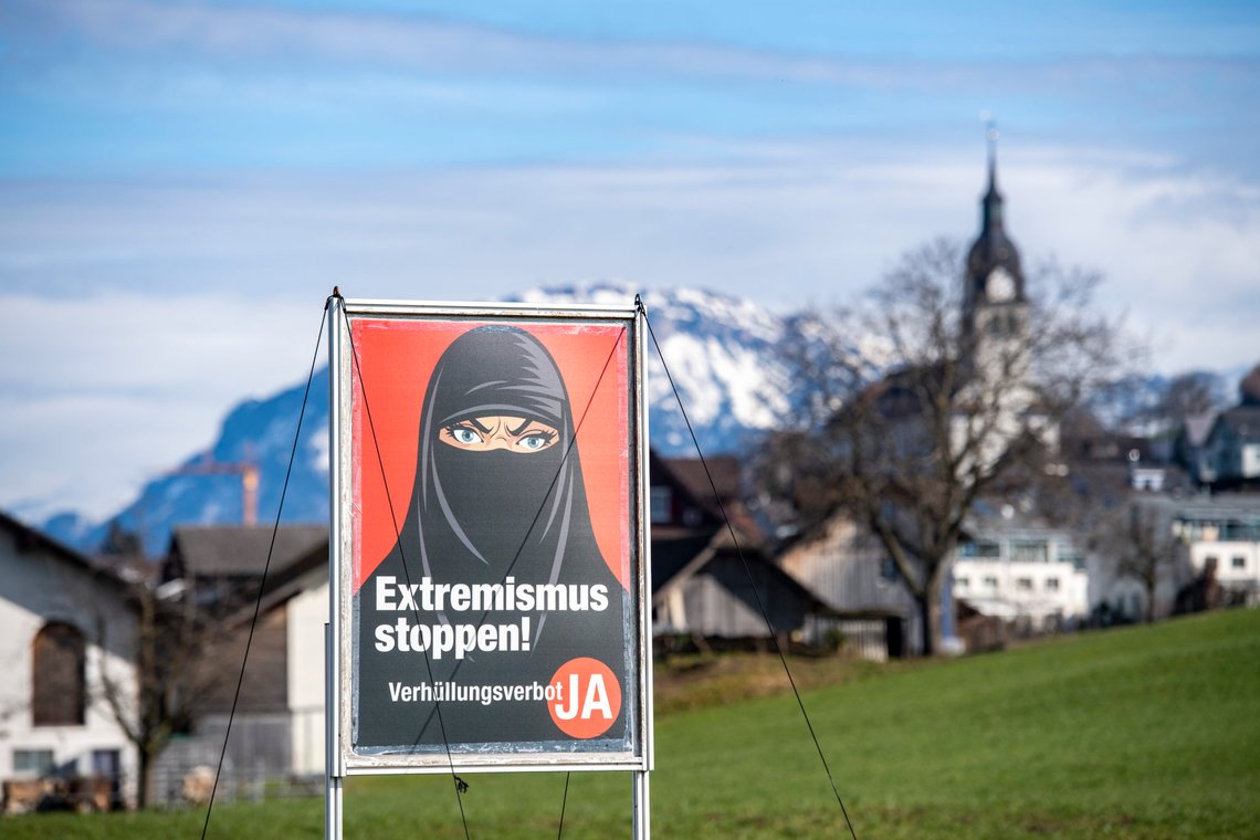 A poster supporting the initiative 'Yes to a ban on covering the face' is displayed at the village Buochs, Switzerland, Tuesday, Feb. 16, 2021. At a time when seemingly everyone in Europe is wearing masks to battle COVID-19, the Swiss go to the polls Sunday March 7, 2021, to vote on a long-laid proposal to ban face-coverings like niqabs and burqas worn by some Muslim women or by protesters in ski masks or bandannas. (Urs Flueeler/Keystone via AP) A poster supporting the initiative 'Yes to a ban on covering the face' is displayed at the village Buochs, Switzerland, Tuesday, Feb. 16, 2021. At a time when seemingly everyone in Europe is wearing masks to battle COVID-19, the Swiss go to the polls Sunday March 7, 2021, to vote on a long-laid proposal to ban face-coverings like niqabs and burqas worn by some Muslim women or by protesters in ski masks or bandannas. (Urs Flueeler/Keystone via AP)