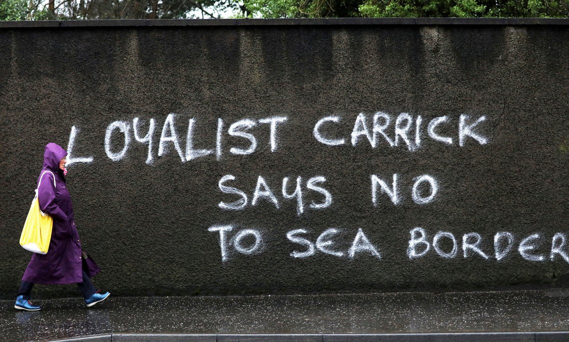 A woman walks past anti Irish Sea Border graffiti in Carrickfergus, Northern Ireland, Wednesday, Feb. 3, 2021. Politicians from Britain, Northern Ireland and the European Union are meeting to defuse post-Brexit trade tensions that have shaken Northern Irelands delicate political balance. British Cabinet minister Michael Gove, European Commission Vice President Maros Sefcovic and the leaders of Northern Irelands Catholic-Protestant power-sharing government will hold a video conference to discuss problems that have erupted barely a month after the U.K. made an economic split from the 27-nation EU. (AP Photo/Peter Morrison) A woman walks past anti Irish Sea Border graffiti in Carrickfergus, Northern Ireland, Wednesday, Feb. 3, 2021. Politicians from Britain, Northern Ireland and the European Union are meeting to defuse post-Brexit trade tensions that have shaken Northern Irelands delicate political balance. British Cabinet minister Michael Gove, European Commission Vice President Maros Sefcovic and the leaders of Northern Irelands Catholic-Protestant power-sharing government will hold a video conference to discuss problems that have erupted barely a month after the U.K. made an economic split from the 27-nation EU. (AP Photo/Peter Morrison)