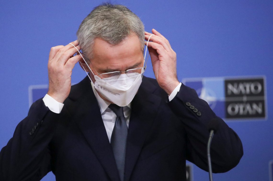 NATO Secretary General Jens Stoltenberg puts on his face mask during an online news conference after he presented the NATO 2020 annual report at the NATO headquarters in Brussels, Tuesday, March 16, 2021. (Yves Herman/Pool Photo via AP) NATO Secretary General Jens Stoltenberg puts on his face mask during an online news conference after he presented the NATO 2020 annual report at the NATO headquarters in Brussels, Tuesday, March 16, 2021. (Yves Herman/Pool Photo via AP)