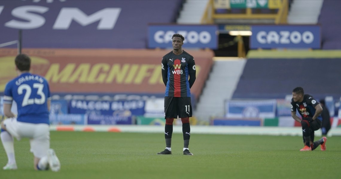 Crystal Palace's Wilfried Zaha stands whilst other players take a knee in support of the Black Lives Matter movement ahead of the English Premier League soccer match between Everton and Crystal Palace at Goodison Park in Liverpool, England, Monday, April 5, 2021.(Jon Super/Pool via AP) Crystal Palace's Wilfried Zaha stands whilst other players take a knee in support of the Black Lives Matter movement ahead of the English Premier League soccer match between Everton and Crystal Palace at Goodison Park in Liverpool, England, Monday, April 5, 2021.(Jon Super/Pool via AP)