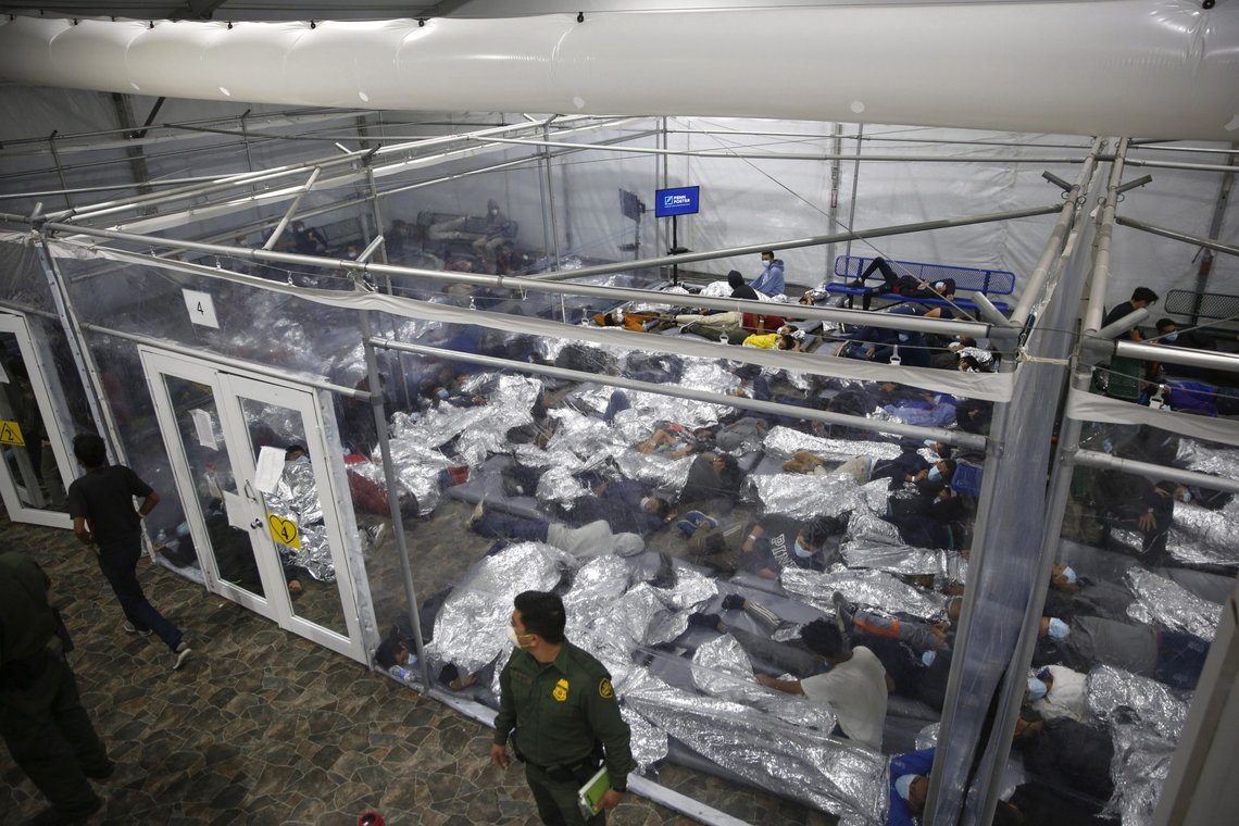 FILE - In this March 30, 2021, file photo, young minors lie inside a pod at the Donna Department of Homeland Security holding facility, the main detention center for unaccompanied children in the Rio Grande Valley run by U.S. Customs and Border Protection (CBP), in Donna, Texas. Migrant families will be held at hotels in the Phoenix area in response to a growing number of people crossing the U.S.-Mexico border, authorities said Friday, April 9, 2021 another step in the Biden administration's rush to set up temporary space for them. (AP Photo/Dario Lopez-Mills, Pool, File) FILE - In this March 30, 2021, file photo, young minors lie inside a pod at the Donna Department of Homeland Security holding facility, the main detention center for unaccompanied children in the Rio Grande Valley run by U.S. Customs and Border Protection (CBP), in Donna, Texas. Migrant families will be held at hotels in the Phoenix area in response to a growing number of people crossing the U.S.-Mexico border, authorities said Friday, April 9, 2021 another step in the Biden administration's rush to set up temporary space for them. (AP Photo/Dario Lopez-Mills, Pool, File)