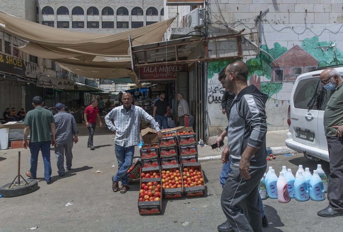 A Palestinian street vendor displays tomatoes for sale in front of a mosque, after Friday prayers during the Muslim fasting month of Ramadan, in the West Bank city of Ramallah, Friday, April 30, 2021. Palestinians mark their second Ramadan amid the coronavirus pandemic while under lockdown measures and COVID-19 restrictions. (AP Photo/Nasser Nasser) A Palestinian street vendor displays tomatoes for sale in front of a mosque, after Friday prayers during the Muslim fasting month of Ramadan, in the West Bank city of Ramallah, Friday, April 30, 2021. Palestinians mark their second Ramadan amid the coronavirus pandemic while under lockdown measures and COVID-19 restrictions. (AP Photo/Nasser Nasser)