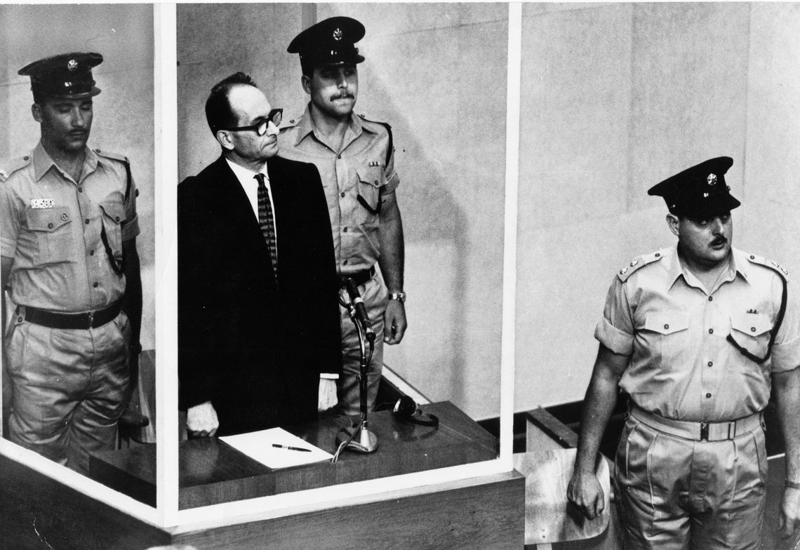 FILE - The 1961 file photo shows Adolf Eichmann standing in his glass cage, flanked by guards, in the Jerusalem courtroom during his trial in 1961 for war crimes committed during World War II. The original glass booth is now shown the first time outside Israel as part of the special exhibition 'Facing Justice - Adolf Eichmann on Trial' at the documentation center placed at the former Gestapo headquarters in Berlin, Germany. (AP Photo, File) FILE - The 1961 file photo shows Adolf Eichmann standing in his glass cage, flanked by guards, in the Jerusalem courtroom during his trial in 1961 for war crimes committed during World War II. The original glass booth is now shown the first time outside Israel as part of the special exhibition 'Facing Justice - Adolf Eichmann on Trial' at the documentation center placed at the former Gestapo headquarters in Berlin, Germany. (AP Photo, File)