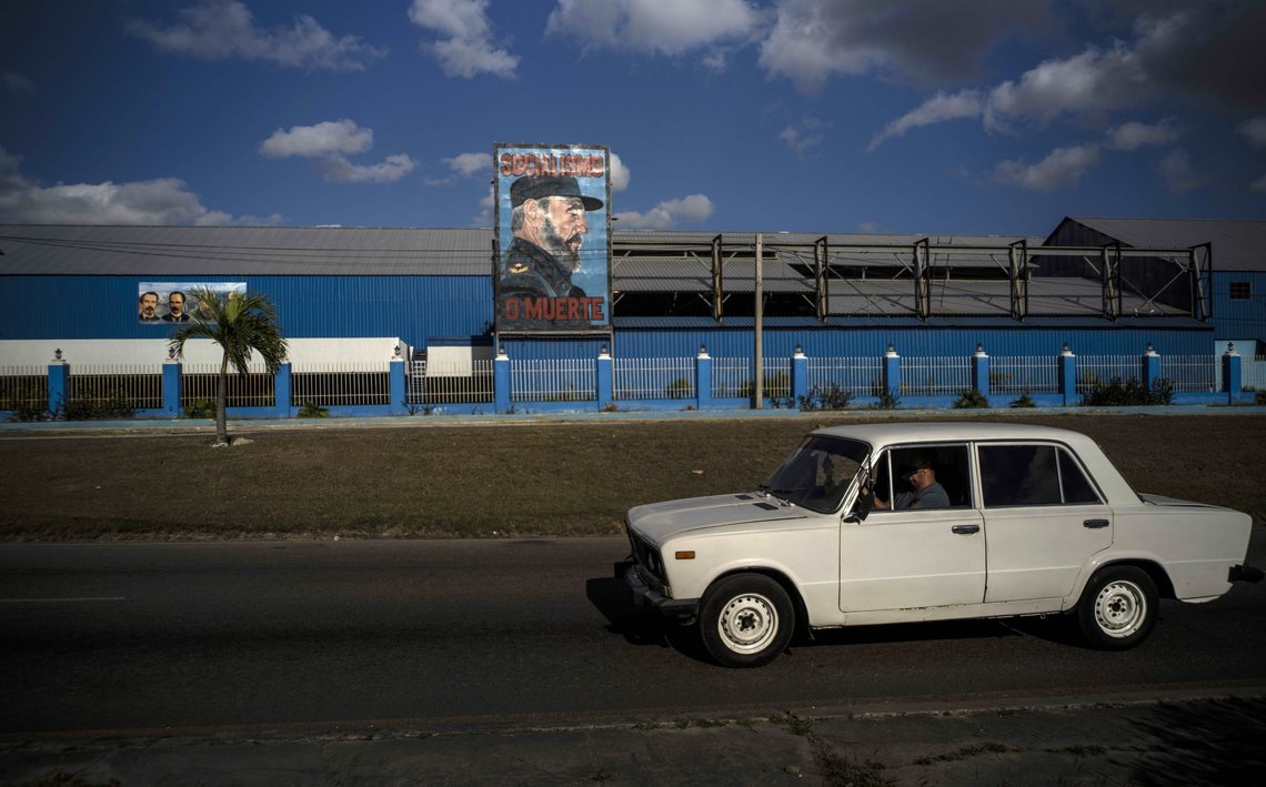 A commuter drives a Soviet-era Lada car past a billboard of the late Fidel Castro with the words "Socialism or Death" written on it in Havana, Cuba, Monday, March 22, 2021. When the Ladas arrived in Cuba they were turned into taxis by the thousands and some went to government offices, the leaders of the Communist Party, and prominent workers. (AP Photo/Ramon Espinosa) A commuter drives a Soviet-era Lada car past a billboard of the late Fidel Castro with the words "Socialism or Death" written on it in Havana, Cuba, Monday, March 22, 2021. When the Ladas arrived in Cuba they were turned into taxis by the thousands and some went to government offices, the leaders of the Communist Party, and prominent workers. (AP Photo/Ramon Espinosa)