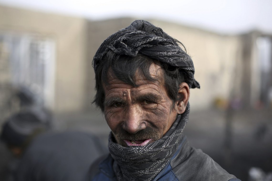 An Afghan laborer poses as he works at a charcoal market on the outskirts of Kabul, Afghanistan, Wednesday, Dec. 18, 2019. In the winter, prices of wood and charcoal rise among all other necessities for Afghans. (AP Photo/Rahmat Gul) An Afghan laborer poses as he works at a charcoal market on the outskirts of Kabul, Afghanistan, Wednesday, Dec. 18, 2019. In the winter, prices of wood and charcoal rise among all other necessities for Afghans. (AP Photo/Rahmat Gul)