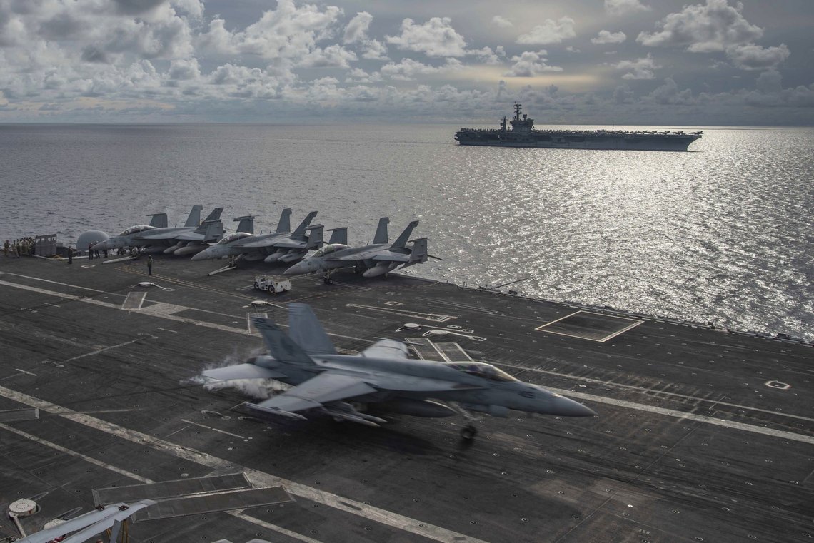 In this photo provided by U.S. Navy, an F/A-18E Super Hornet lands on the flight deck of the USS Ronald Reagan (CVN 76), as USS Nimitz (CVN 68) steams alongside in the South China Sea, Monday, July 6, 2020. China on Monday, July 6, accused the U.S. of flexing its military muscles in the South China Sea by conducting joint exercises with two U.S. aircraft carrier groups in the strategic waterway.(Mass Communication Specialist 2nd Class Samantha Jetzer/U.S. Navy via AP) In this photo provided by U.S. Navy, an F/A-18E Super Hornet lands on the flight deck of the USS Ronald Reagan (CVN 76), as USS Nimitz (CVN 68) steams alongside in the South China Sea, Monday, July 6, 2020. China on Monday, July 6, accused the U.S. of flexing its military muscles in the South China Sea by conducting joint exercises with two U.S. aircraft carrier groups in the strategic waterway.(Mass Communication Specialist 2nd Class Samantha Jetzer/U.S. Navy via AP)
