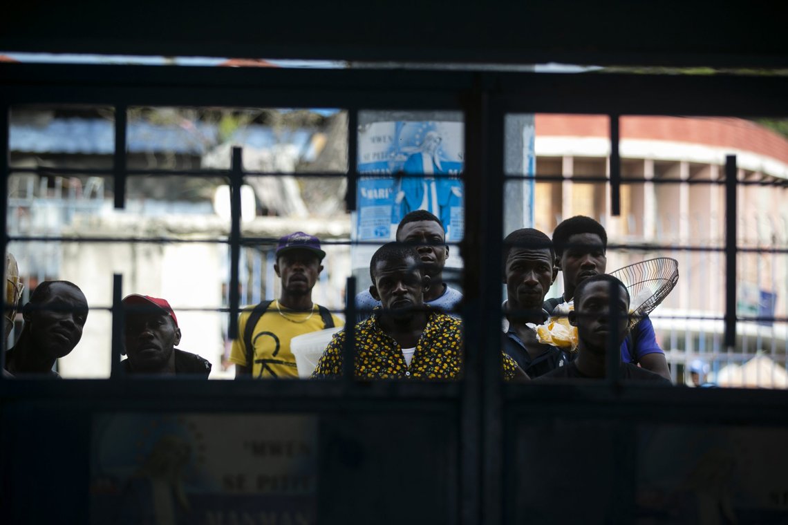Fans get to see part of the game through a gate as they stand outside the stadium during a CONCACAF World Cup qualifying soccer match between Haiti and Belize in Port-au-prince, Haiti, Thursday, March 25, 2021. ( AP Photo/ Dieu Nalio Chery) Fans get to see part of the game through a gate as they stand outside the stadium during a CONCACAF World Cup qualifying soccer match between Haiti and Belize in Port-au-prince, Haiti, Thursday, March 25, 2021. ( AP Photo/ Dieu Nalio Chery)