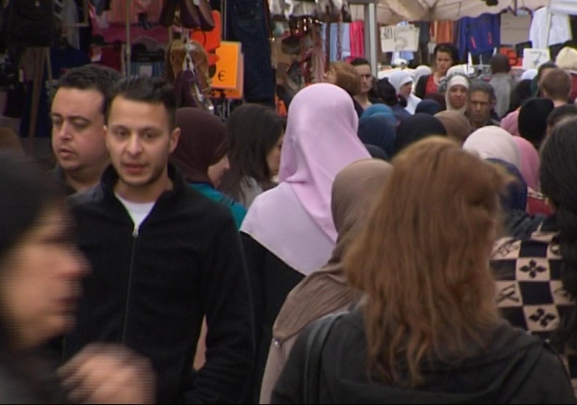 This is an image taken from video on Wednesday April 13, 2016 of of Salah Abdeslam, 2nd left, the fugitive from the Nov. 13 Paris attacks whose capture appears to have precipitated the March 22 bombing in Brussels. In the August 2014 Tvbrussel footage revealed Wednesday, Abdeslam is seen strolling casually through the Molenbeek market. Abdeslam, like many of the men in the Islamic State cell blamed for the pair of deadly attacks, is a native of the Brussels neighborhood. (Tvbrussels via AP) BELGIUM OUT This is an image taken from video on Wednesday April 13, 2016 of of Salah Abdeslam, 2nd left, the fugitive from the Nov. 13 Paris attacks whose capture appears to have precipitated the March 22 bombing in Brussels. In the August 2014 Tvbrussel footage revealed Wednesday, Abdeslam is seen strolling casually through the Molenbeek market. Abdeslam, like many of the men in the Islamic State cell blamed for the pair of deadly attacks, is a native of the Brussels neighborhood. (Tvbrussels via AP) BELGIUM OUT