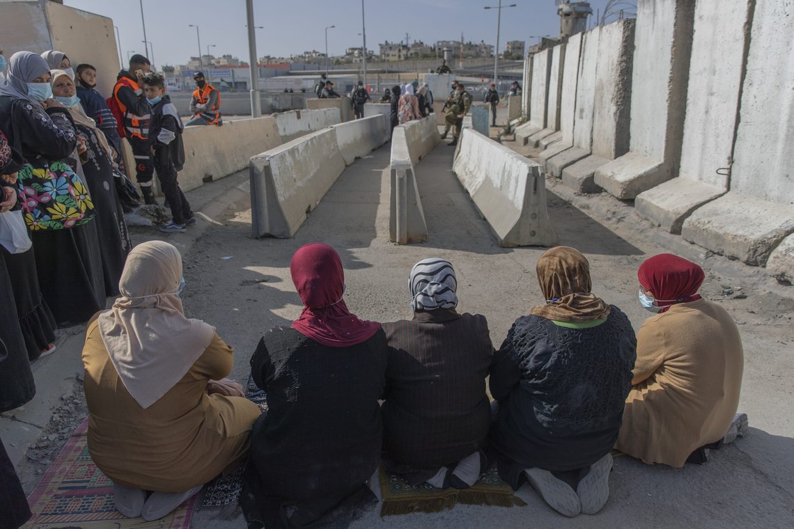 Palestinian women prepare to pray at the Qalandia checkpoint, to protest not allowing them to cross from the West Bank city of Ramallah toward Jerusalem, to attend the first Friday prayers in al-Aqsa mosque, during the Muslim holy month of Ramadan, Friday, April 16, 2021. A limited number of Palestinian residents who carry both a travel permit and a vaccination document, are allowed to cross into Israel to attend the prayers at al-Aqsa mosque, due to the coronavirus pandemic. (AP Photo/Nasser Nasser) Palestinian women prepare to pray at the Qalandia checkpoint, to protest not allowing them to cross from the West Bank city of Ramallah toward Jerusalem, to attend the first Friday prayers in al-Aqsa mosque, during the Muslim holy month of Ramadan, Friday, April 16, 2021. A limited number of Palestinian residents who carry both a travel permit and a vaccination document, are allowed to cross into Israel to attend the prayers at al-Aqsa mosque, due to the coronavirus pandemic. (AP Photo/Nasser Nasser)