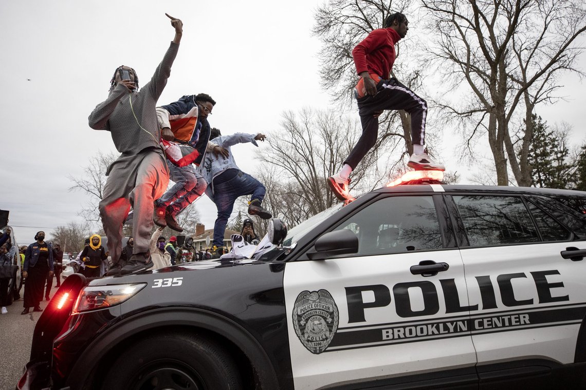 Men jump on police vehicles near the site of a shooting involving a police officer, Sunday, April 11, 2021, in Brooklyn Center, Minn. (Carlos Gonzalez/Star Tribune via AP) Men jump on police vehicles near the site of a shooting involving a police officer, Sunday, April 11, 2021, in Brooklyn Center, Minn. (Carlos Gonzalez/Star Tribune via AP)