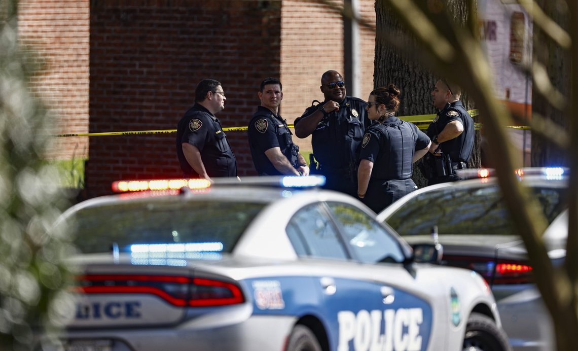 Knoxville police work the scene following a shooting at Austin-East Magnet High School in Knoxville, Tenn., Monday, April 12, 2021. (AP Photo/Wade Payne) Knoxville police work the scene following a shooting at Austin-East Magnet High School in Knoxville, Tenn., Monday, April 12, 2021. (AP Photo/Wade Payne)