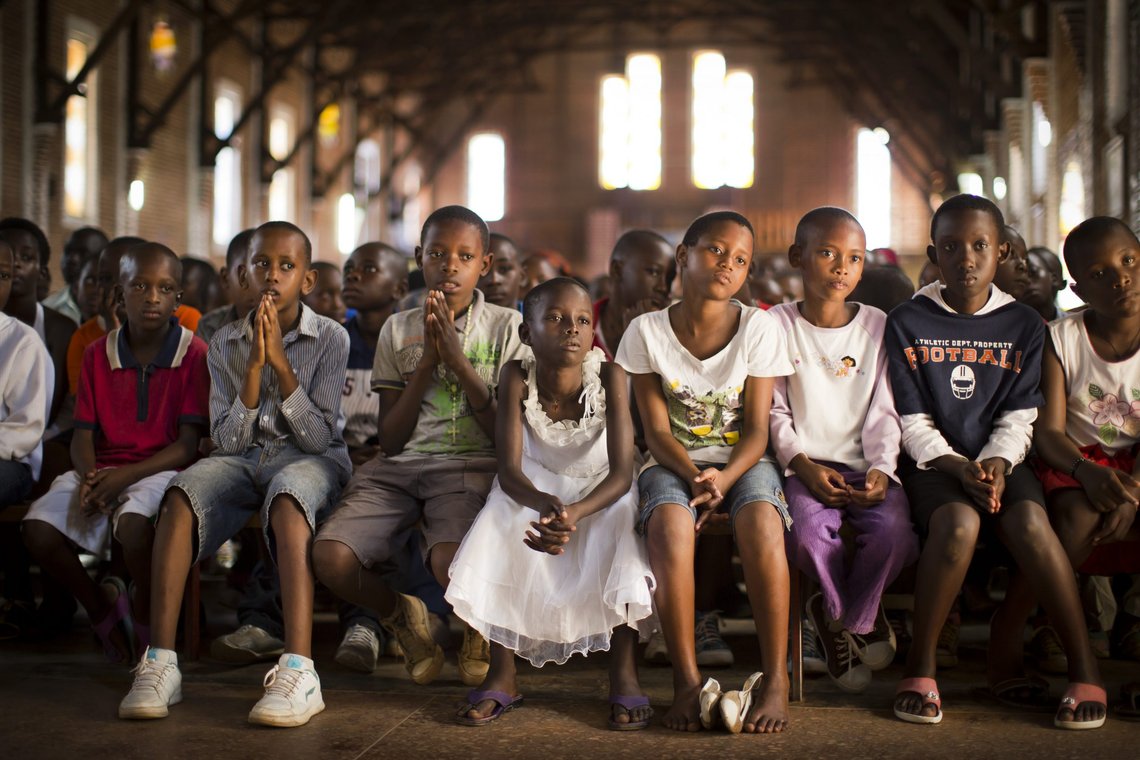 FILE - In this Sunday, April 6, 2014 file photo, Rwandan children listen and pray during a Sunday morning service at the Saint-Famille Catholic church, the scene of many killings during the 1994 genocide, in the capital Kigali, Rwanda, a day before the 20-year anniversary of the genocide. (AP Photo/Ben Curtis, File) FILE - In this Sunday, April 6, 2014 file photo, Rwandan children listen and pray during a Sunday morning service at the Saint-Famille Catholic church, the scene of many killings during the 1994 genocide, in the capital Kigali, Rwanda, a day before the 20-year anniversary of the genocide. (AP Photo/Ben Curtis, File)