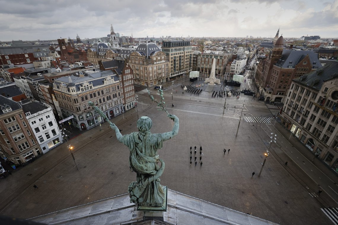 View of Dam Square, devoid of spectators due to coronavirus related restrictions, as Dutch King Willem-Alexander and Queen Maxima lay a wreath during a national service to commemorate the war dead in Amsterdam, Netherlands, Tuesday, May 4, 2021. (Remko de Waal/Pool via AP) View of Dam Square, devoid of spectators due to coronavirus related restrictions, as Dutch King Willem-Alexander and Queen Maxima lay a wreath during a national service to commemorate the war dead in Amsterdam, Netherlands, Tuesday, May 4, 2021. (Remko de Waal/Pool via AP)