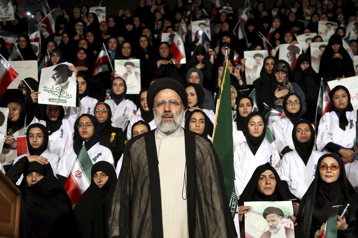FILE - In this April 29, 2017, file photo, Iranian cleric and presidential candidate Ebrahim Raisi, center, stands among his supporters, during a campaign rally in Tehran, Iran. Raisi, a prominent hard-line cleric who now serves as Iran's judiciary chief, registered Saturday, May 15, 2021, to run in Iran's upcoming presidential election. (AP Photo/Ebrahim Noroozi, File) FILE - In this April 29, 2017, file photo, Iranian cleric and presidential candidate Ebrahim Raisi, center, stands among his supporters, during a campaign rally in Tehran, Iran. Raisi, a prominent hard-line cleric who now serves as Iran's judiciary chief, registered Saturday, May 15, 2021, to run in Iran's upcoming presidential election. (AP Photo/Ebrahim Noroozi, File)