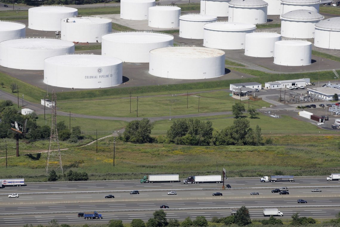 FILE - In this Sept. 8, 2008 file photo traffic on I-95 passes oil storage tanks owned by the Colonial Pipeline Company in Linden, N.J. A major pipeline that transports fuels along the East Coast says it had to stop operations because it was the victim of a cyberattack. Colonial Pipeline said in a statement late Friday that it took certain systems offline to contain the threat, which has temporarily halted all pipeline operations, and affected some of our IT systems. (AP Photo/Mark Lennihan, File) FILE - In this Sept. 8, 2008 file photo traffic on I-95 passes oil storage tanks owned by the Colonial Pipeline Company in Linden, N.J. A major pipeline that transports fuels along the East Coast says it had to stop operations because it was the victim of a cyberattack. Colonial Pipeline said in a statement late Friday that it took certain systems offline to contain the threat, which has temporarily halted all pipeline operations, and affected some of our IT systems. (AP Photo/Mark Lennihan, File)