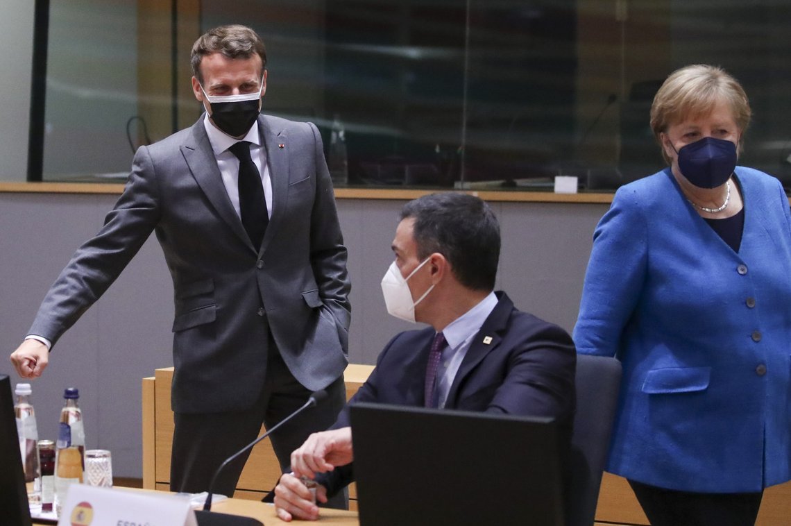 German Chancellor Angela Merkel, right, speaks with French President Emmanuel Macron, left, and Spain's Prime Minister Pedro Sanchez, center, during a round table meeting at an EU summit in Brussels, Monday, May 24, 2021. European Union leaders are expected, during a two day in-person meeting, to focus on foreign relations, including Russia and the UK. (Yves Herman, Pool via AP) German Chancellor Angela Merkel, right, speaks with French President Emmanuel Macron, left, and Spain's Prime Minister Pedro Sanchez, center, during a round table meeting at an EU summit in Brussels, Monday, May 24, 2021. European Union leaders are expected, during a two day in-person meeting, to focus on foreign relations, including Russia and the UK. (Yves Herman, Pool via AP)