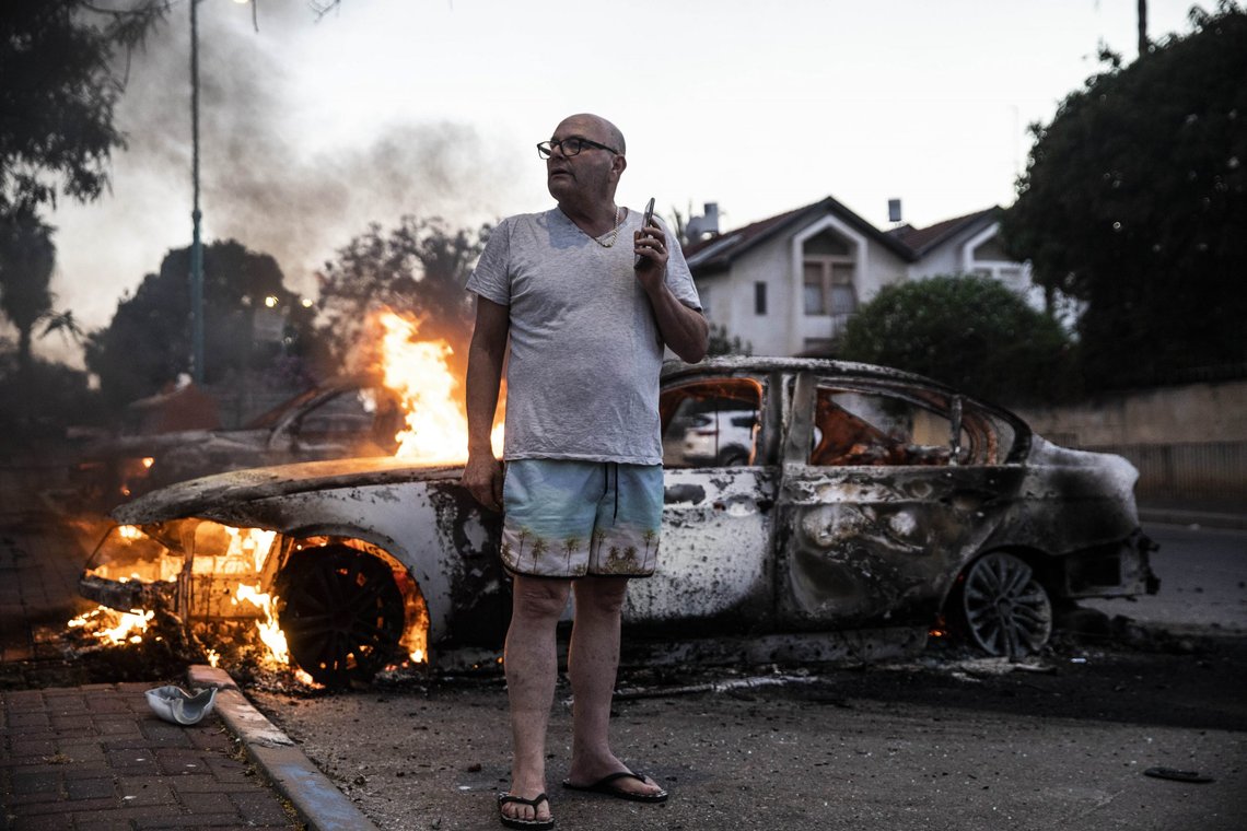 Jacob Simona stands by his burning car during clashes with Israeli Arabs and police in the Israeli mixed city of Lod, Israel Tuesday, May 11,2021. (AP Photo/Heidi Levine) Jacob Simona stands by his burning car during clashes with Israeli Arabs and police in the Israeli mixed city of Lod, Israel Tuesday, May 11,2021. (AP Photo/Heidi Levine)