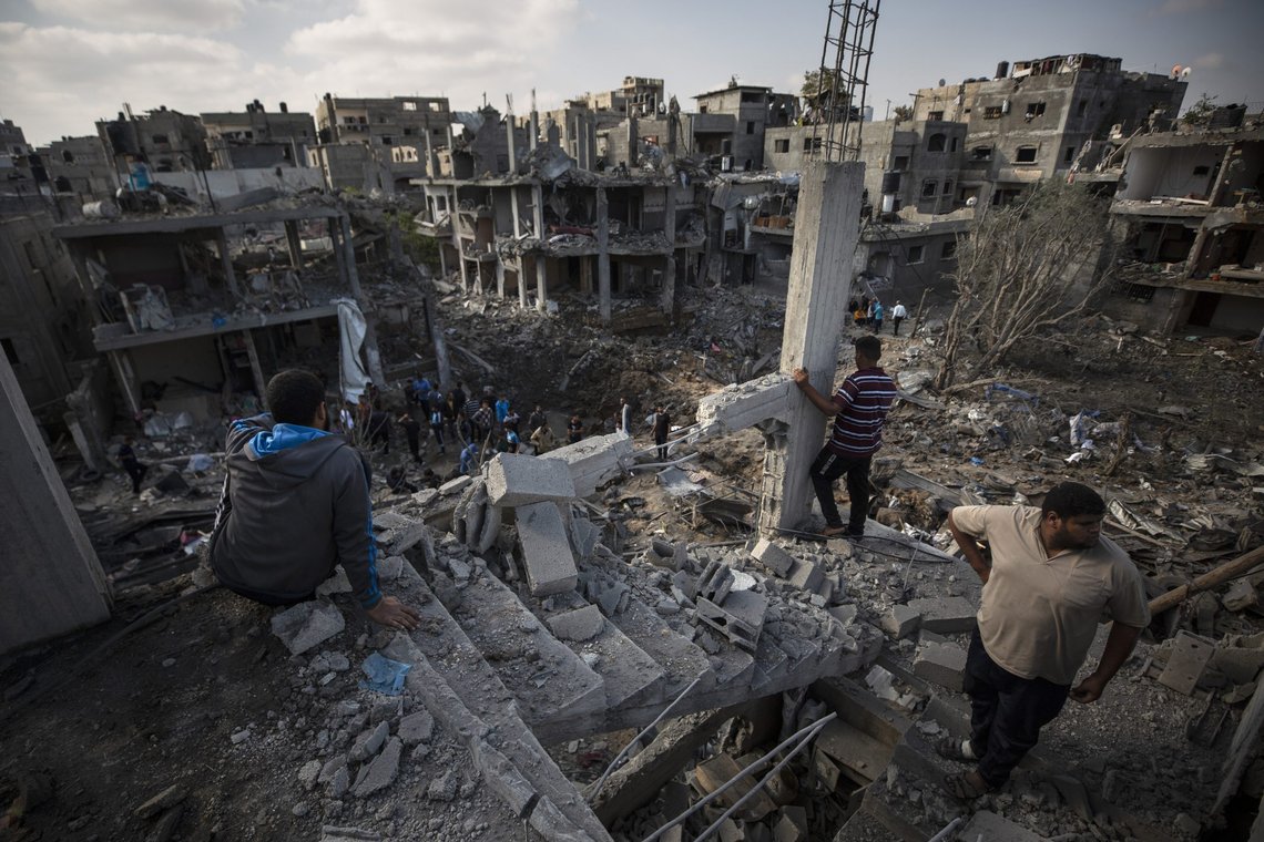 Palestinians inspect their destroyed houses following overnight Israeli airstrikes in town of Beit Hanoun, northern Gaza Strip, Friday, May 14, 2021. (AP Photo/Khalil Hamra) Palestinians inspect their destroyed houses following overnight Israeli airstrikes in town of Beit Hanoun, northern Gaza Strip, Friday, May 14, 2021. (AP Photo/Khalil Hamra)
