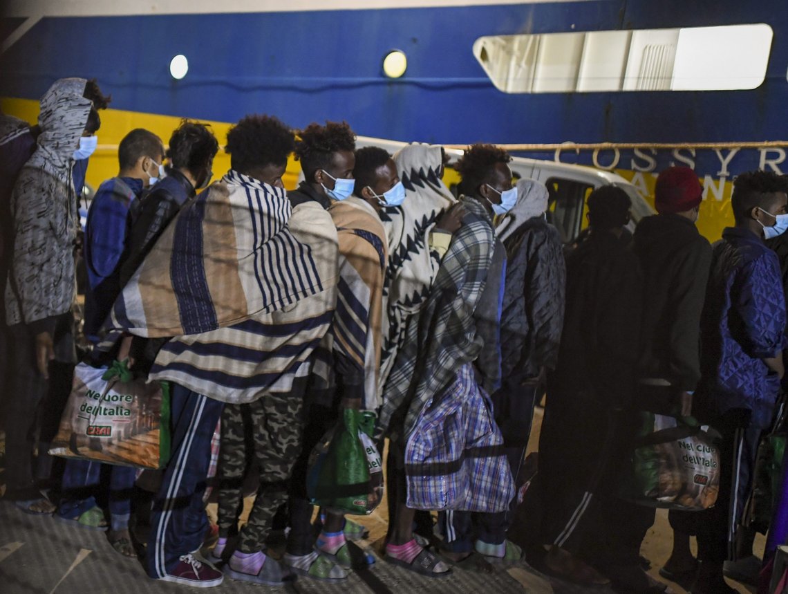 Some 80 unaccompanied minors from the island of Lampedusa's migrant housing center, Sicily, are embarked on the ship Cossyra, Wednesday, May 12, 2021, bound to the Sicilian town of Porto Empedocle. Hundreds more migrants were being transferred to an unused passenger ferry offshore for quarantine until they can be tested for COVID-19. Another commercial passenger ship was being dispatched to Lampedusa to take on some more. (AP Photo/Salvatore Cavalli) Some 80 unaccompanied minors from the island of Lampedusa's migrant housing center, Sicily, are embarked on the ship Cossyra, Wednesday, May 12, 2021, bound to the Sicilian town of Porto Empedocle. Hundreds more migrants were being transferred to an unused passenger ferry offshore for quarantine until they can be tested for COVID-19. Another commercial passenger ship was being dispatched to Lampedusa to take on some more. (AP Photo/Salvatore Cavalli)