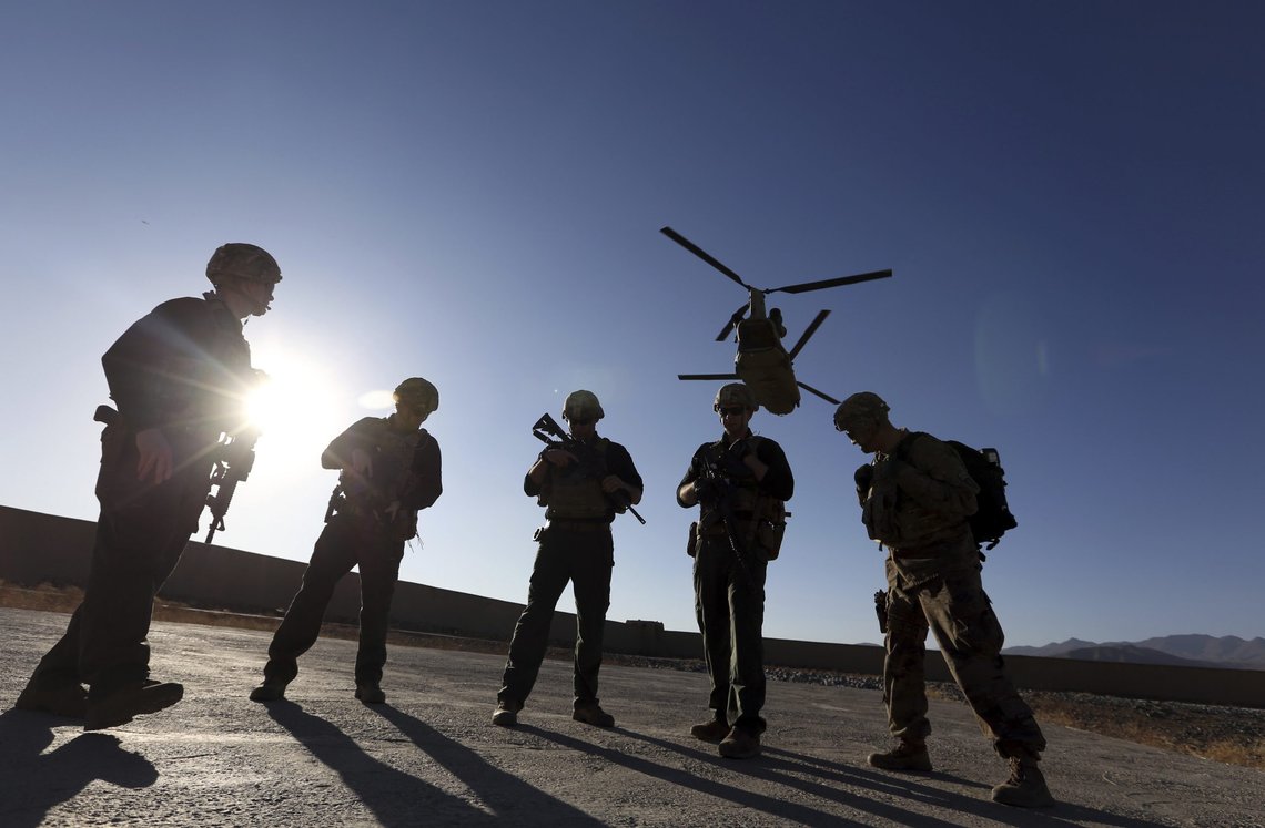 FILE - In this Nov. 30, 2017, file photo, American soldiers wait on the tarmac in Logar province, Afghanistan. With American troops withdrawing from Afghanistan, pressure has been mounting for the Biden administration to plan a military evacuation of Afghans who supported U.S. military operations during two decades of war in their country. (AP Photo/Rahmat Gul, File) FILE - In this Nov. 30, 2017, file photo, American soldiers wait on the tarmac in Logar province, Afghanistan. With American troops withdrawing from Afghanistan, pressure has been mounting for the Biden administration to plan a military evacuation of Afghans who supported U.S. military operations during two decades of war in their country. (AP Photo/Rahmat Gul, File)