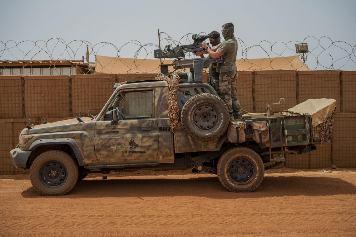 French Barkhane force commandos mount a machine gun on a camouflaged pickup as Malian workers drive by before heading on a mission from their base in Gao, Mali Monday June 7, 2021. After France suspended joint military operations with Malian forces after the junta led by Col. Assimi Goita retook control of Mali's transitional government May 24 2021, French President Emmanuel Macron announced at a press conference Thursday June 10, 2021, that operation Barkhane would end and be replaced by support for local partners and counter terrorism. French Barkhane force commandos mount a machine gun on a camouflaged pickup as Malian workers drive by before heading on a mission from their base in Gao, Mali Monday June 7, 2021. After France suspended joint military operations with Malian forces after the junta led by Col. Assimi Goita retook control of Mali's transitional government May 24 2021, French President Emmanuel Macron announced at a press conference Thursday June 10, 2021, that operation Barkhane would end and be replaced by support for local partners and counter terrorism.