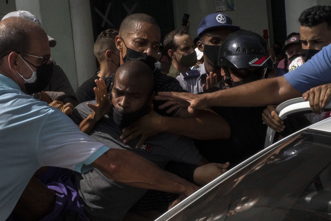 Police detain an anti-government demonstrator during a protest in Havana, Cuba, Sunday July 11, 2021. Hundreds of demonstrators went out to the streets in several cities in Cuba to protest against ongoing food shortages and high prices of foodstuffs, amid the new coronavirus crisis. (AP Photo/Ramon Espinosa) Police detain an anti-government demonstrator during a protest in Havana, Cuba, Sunday July 11, 2021. Hundreds of demonstrators went out to the streets in several cities in Cuba to protest against ongoing food shortages and high prices of foodstuffs, amid the new coronavirus crisis. (AP Photo/Ramon Espinosa)