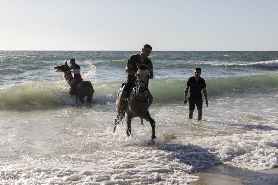 Bedouins ride their horses in the Mediterranean Sea during the Muslim Eid al-Adha holiday at Zikim beach, on the Israeli-Gaza border, Wednesday, July 21, 2021. (AP Photo/Tsafrir Abayov) Bedouins ride their horses in the Mediterranean Sea during the Muslim Eid al-Adha holiday at Zikim beach, on the Israeli-Gaza border, Wednesday, July 21, 2021. (AP Photo/Tsafrir Abayov)