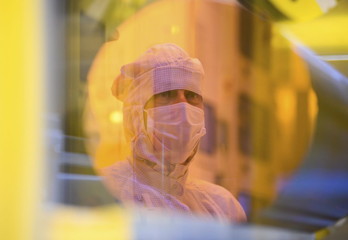 An associate is reflected in a 300-millimeter wafer in the clean room during a press tour of the new semiconductor factory of the Bosch company in Dresden, Germany, May 31, 2021. The chip factory will officially start working on June 7, 2021. (Robert Michael/dpa via AP) An associate is reflected in a 300-millimeter wafer in the clean room during a press tour of the new semiconductor factory of the Bosch company in Dresden, Germany, May 31, 2021. The chip factory will officially start working on June 7, 2021. (Robert Michael/dpa via AP)