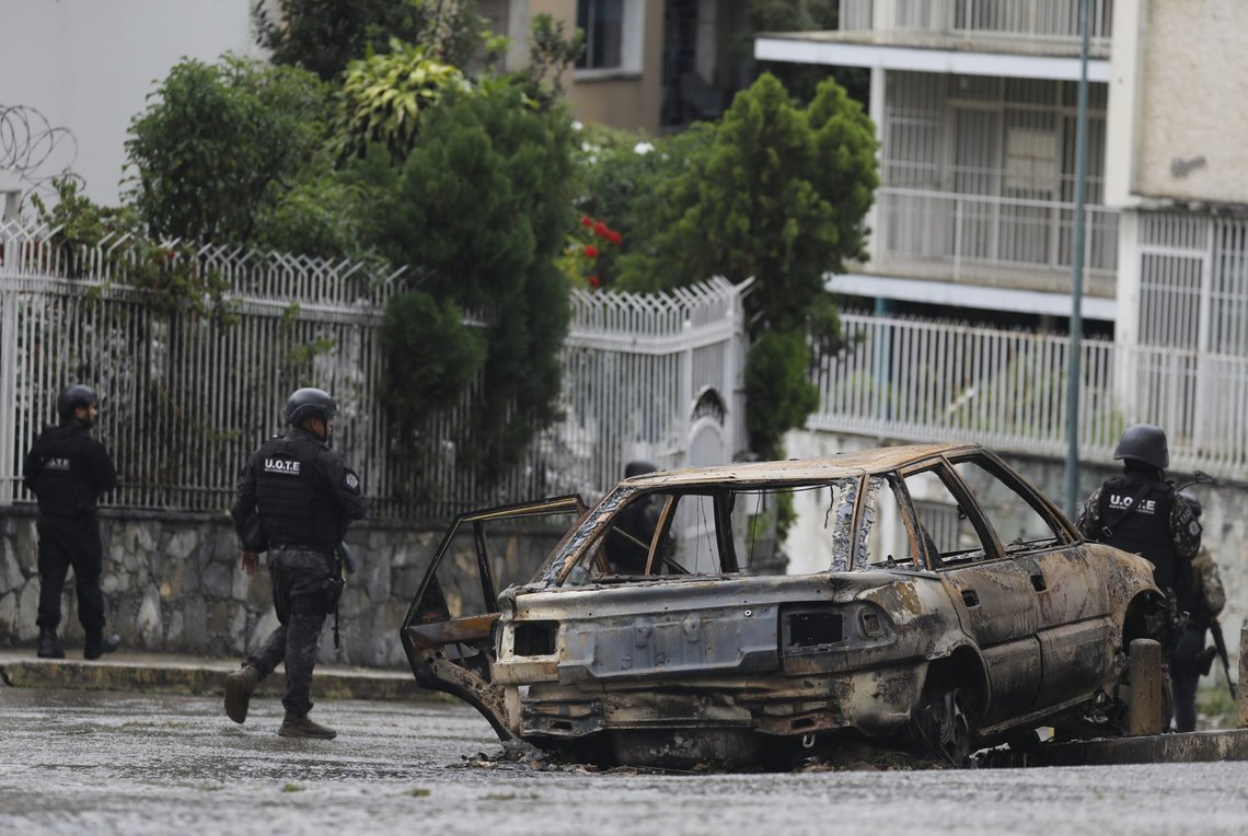 Members of the Special Tactical Operations Unit, walk past the shell of charred vehicle in the Cota 905 neighborhood, in Caracas, Venezuela, Friday, July 9, 2021. The government has deployed police and military into Cota 905, one of the most dangerous neighborhoods of Caracas, looking to capture the leaders of the Koki gang, one of the largest criminal gangs in Venezuela. (AP Photo/Ariana Cubillos) Members of the Special Tactical Operations Unit, walk past the shell of charred vehicle in the Cota 905 neighborhood, in Caracas, Venezuela, Friday, July 9, 2021. The government has deployed police and military into Cota 905, one of the most dangerous neighborhoods of Caracas, looking to capture the leaders of the Koki gang, one of the largest criminal gangs in Venezuela. (AP Photo/Ariana Cubillos)