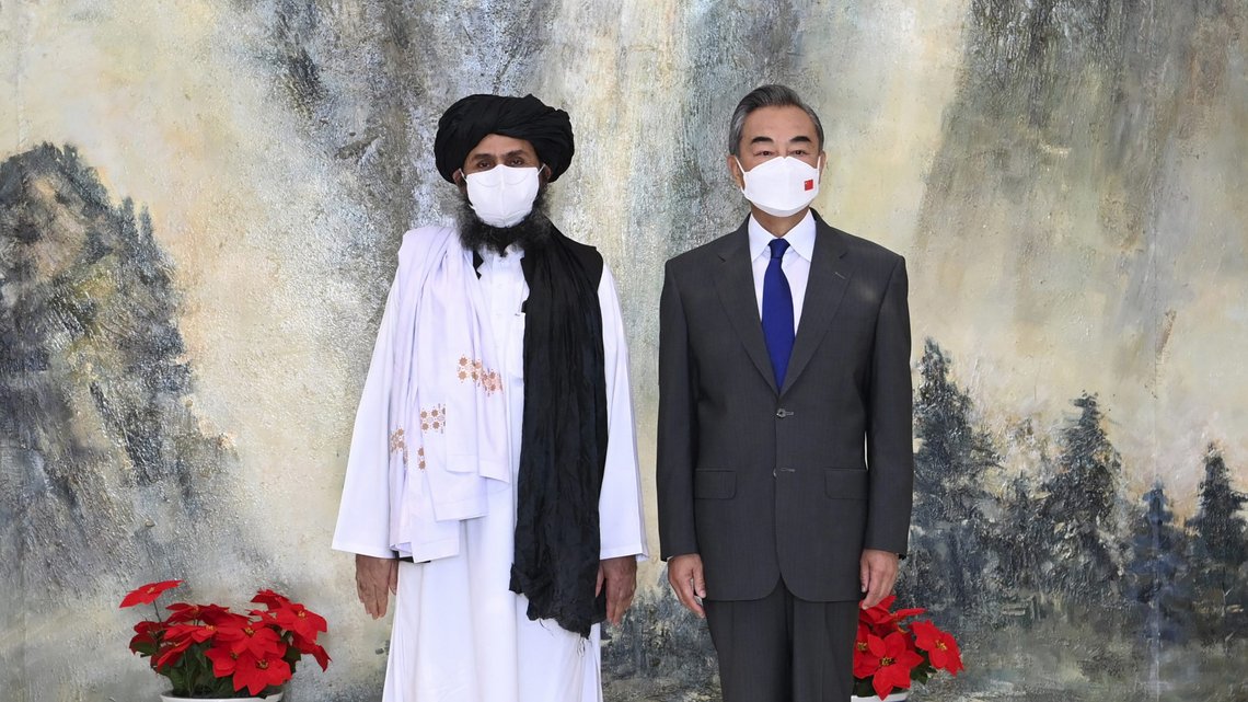 In this photo released by China's Xinhua News Agency, Taliban co-founder Mullah Abdul Ghani Baradar, left, and Chinese Foreign Minister Wang Yi pose for a photo during their meeting in Tianjin, China, Wednesday, July 28, 2021. Wang met with a delegation of high-level Taliban officials as ties between them warm ahead of the U.S. pullout from Afghanistan. (Li Ran/Xinhua via AP) In this photo released by China's Xinhua News Agency, Taliban co-founder Mullah Abdul Ghani Baradar, left, and Chinese Foreign Minister Wang Yi pose for a photo during their meeting in Tianjin, China, Wednesday, July 28, 2021. Wang met with a delegation of high-level Taliban officials as ties between them warm ahead of the U.S. pullout from Afghanistan. (Li Ran/Xinhua via AP)