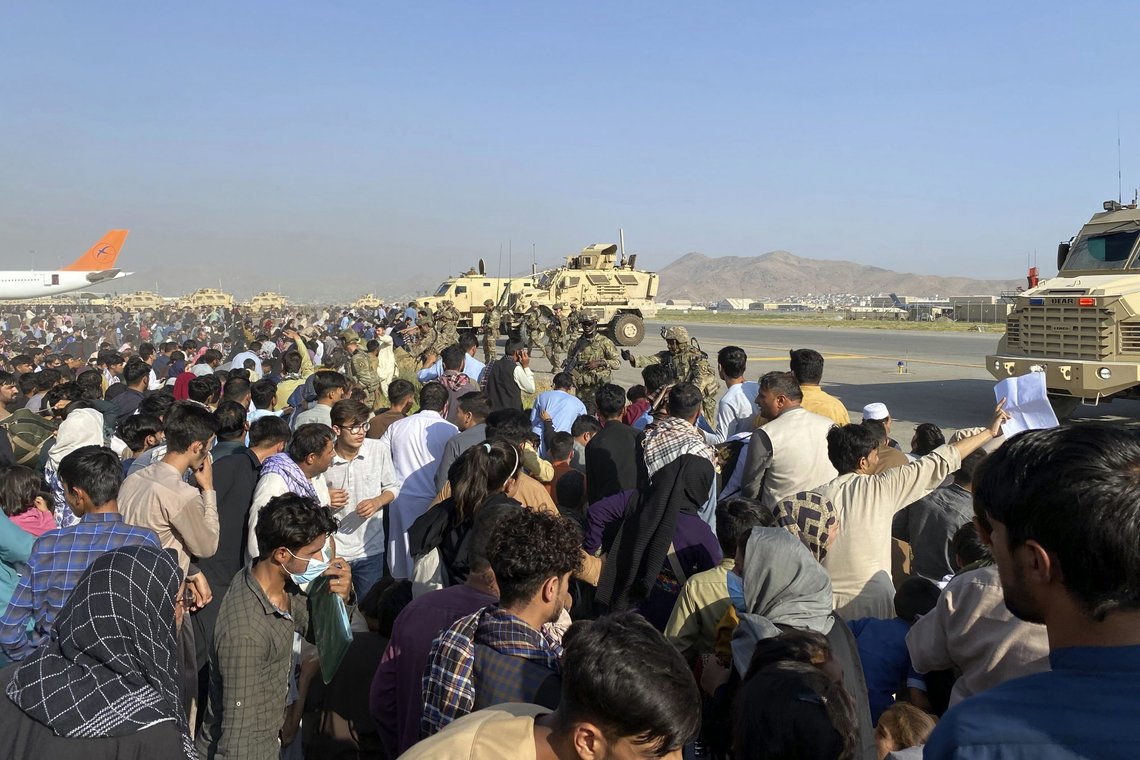 U.S soldiers stand guard along a perimeter at the international airport in Kabul, Afghanistan, Monday, Aug. 16, 2021. On Monday, the U.S. military and officials focus was on Kabuls airport, where thousands of Afghans trapped by the sudden Taliban takeover rushed the tarmac and clung to U.S. military planes deployed to fly out staffers of the U.S. Embassy, which shut down Sunday, and others. (AP Photo/Shekib Rahmani) U.S soldiers stand guard along a perimeter at the international airport in Kabul, Afghanistan, Monday, Aug. 16, 2021. On Monday, the U.S. military and officials focus was on Kabuls airport, where thousands of Afghans trapped by the sudden Taliban takeover rushed the tarmac and clung to U.S. military planes deployed to fly out staffers of the U.S. Embassy, which shut down Sunday, and others. (AP Photo/Shekib Rahmani)