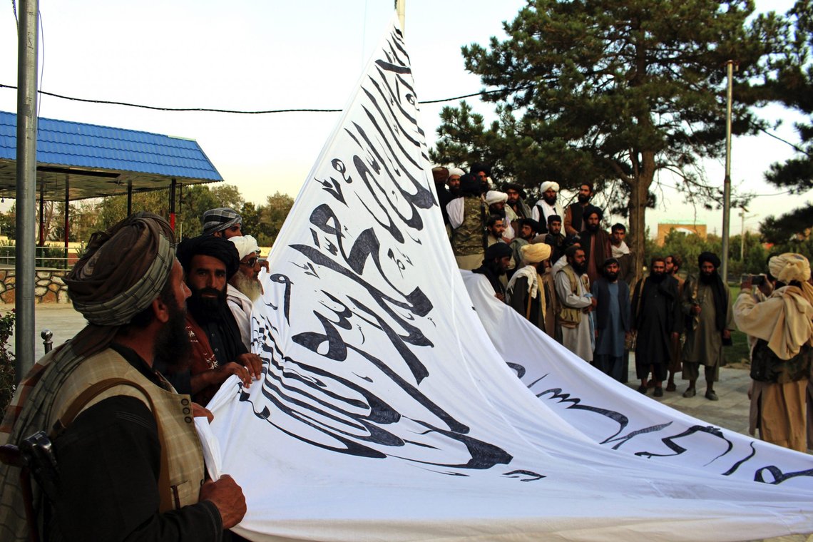 Taliban fighters raise their flag at the Ghazni provincial governor's house, in Ghazni, southeastern, Afghanistan, Sunday, Aug. 15, 2021. (AP Photo/Gulabuddin Amiri) Taliban fighters raise their flag at the Ghazni provincial governor's house, in Ghazni, southeastern, Afghanistan, Sunday, Aug. 15, 2021. (AP Photo/Gulabuddin Amiri)