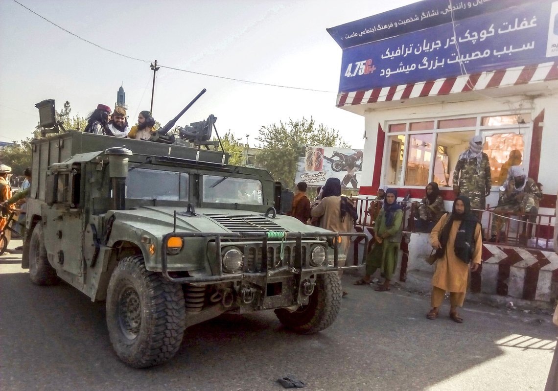 FILE - In this Monday, Aug. 9, 2021 file photo, Taliban fighters stand guard at a checkpoint in Kunduz city, northern Afghanistan. As the Taliban took control of Afghanistan in a swift power grab, thousands of Afghans have been looking for ways to escape what they see as a return of a ruthless fundamentalist rule. But the neighboring Uzbekistan doesn't appear eager to help the stranded nation. (AP Photo/Abdullah Sahil, File) FILE - In this Monday, Aug. 9, 2021 file photo, Taliban fighters stand guard at a checkpoint in Kunduz city, northern Afghanistan. As the Taliban took control of Afghanistan in a swift power grab, thousands of Afghans have been looking for ways to escape what they see as a return of a ruthless fundamentalist rule. But the neighboring Uzbekistan doesn't appear eager to help the stranded nation. (AP Photo/Abdullah Sahil, File)