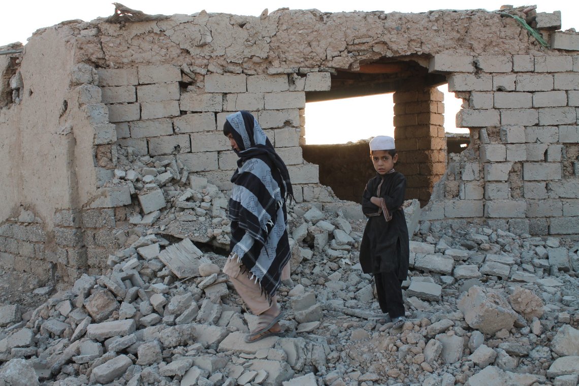 Boys walk past a house damaged by airstrikes two weeks earlier during a fight between government forces and the Taliban, in Lashkar Gah, Helmand province, southwestern Afghanistan, Saturday, Aug. 21, 2021. (AP Photo/Abdul Khaliq) Boys walk past a house damaged by airstrikes two weeks earlier during a fight between government forces and the Taliban, in Lashkar Gah, Helmand province, southwestern Afghanistan, Saturday, Aug. 21, 2021. (AP Photo/Abdul Khaliq)