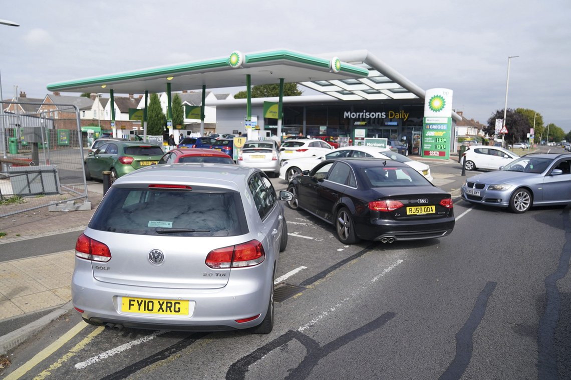 Cars queue outside a petrol station in Leicester, England, Saturday Sept. 25, 2021. The haulage industry says the U.K. is short tens of thousands of truckers, due to a perfect storm of factors including the coronavirus pandemic, an aging workforce and an exodus of European Union workers following Britains departure from the bloc. BP and Esso shut a handful of their gas stations this week, and motorists have formed long lines as they try to fill up in case of further disruption. (Mike Egerton//PA via AP) Cars queue outside a petrol station in Leicester, England, Saturday Sept. 25, 2021. The haulage industry says the U.K. is short tens of thousands of truckers, due to a perfect storm of factors including the coronavirus pandemic, an aging workforce and an exodus of European Union workers following Britains departure from the bloc. BP and Esso shut a handful of their gas stations this week, and motorists have formed long lines as they try to fill up in case of further disruption. (Mike Egerton//PA via AP)