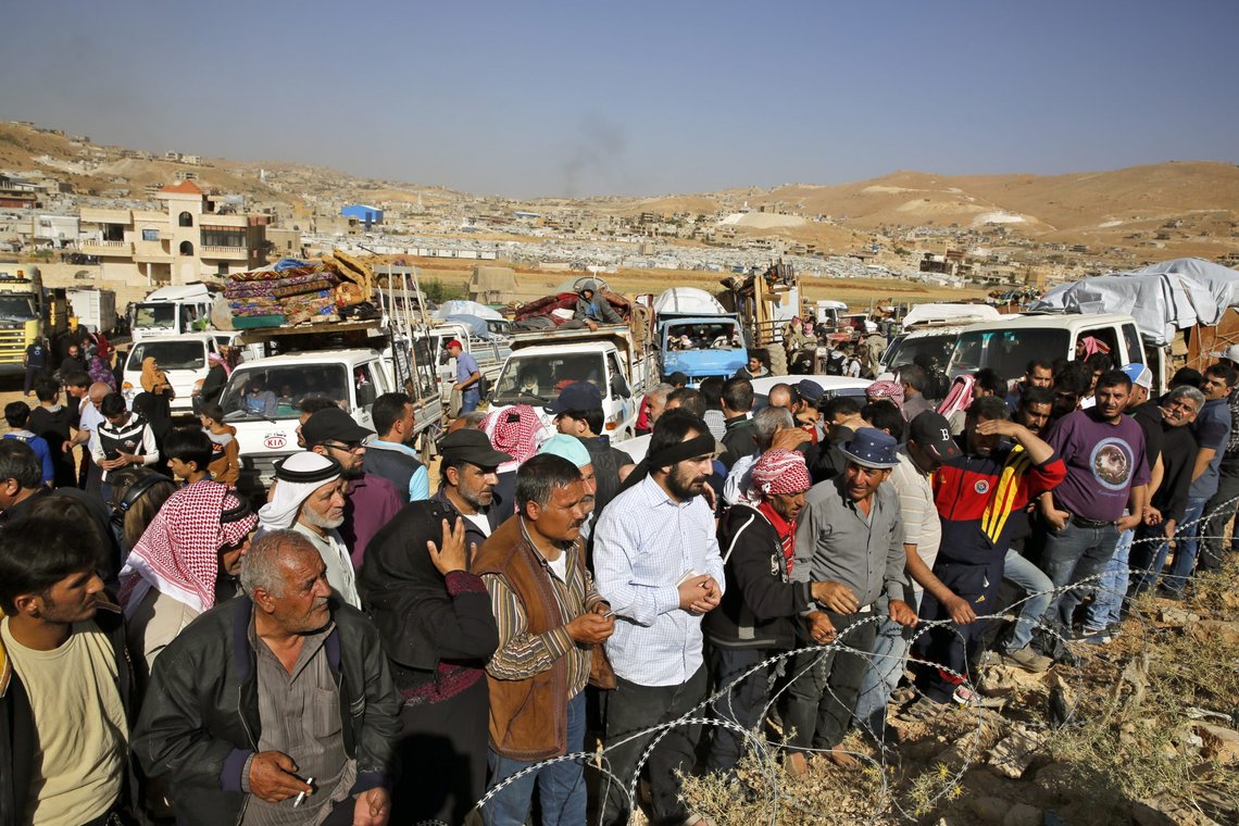 FILE - In this June 28, 2018 file photo, Syrian refugees gather in and near their vehicles getting ready to cross into Syria from the eastern Lebanese border town of Arsal, Lebanon. A number of Syrian refugees who returned home have been subjected to detention, disappearance and torture at the hands of Syrian security forces, proving that it still isn't safe to return to any part of the country, Amnesty International said in a new report released Tuesday, Sept. 7, 2021. It documents what it said were violations committed by Syrian intelligence officers against some returnees, including 13 children between mid-2017 and spring 2021. (AP Photo/Bilal Hussein, File) FILE - In this June 28, 2018 file photo, Syrian refugees gather in and near their vehicles getting ready to cross into Syria from the eastern Lebanese border town of Arsal, Lebanon. A number of Syrian refugees who returned home have been subjected to detention, disappearance and torture at the hands of Syrian security forces, proving that it still isn't safe to return to any part of the country, Amnesty International said in a new report released Tuesday, Sept. 7, 2021. It documents what it said were violations committed by Syrian intelligence officers against some returnees, including 13 children between mid-2017 and spring 2021. (AP Photo/Bilal Hussein, File)