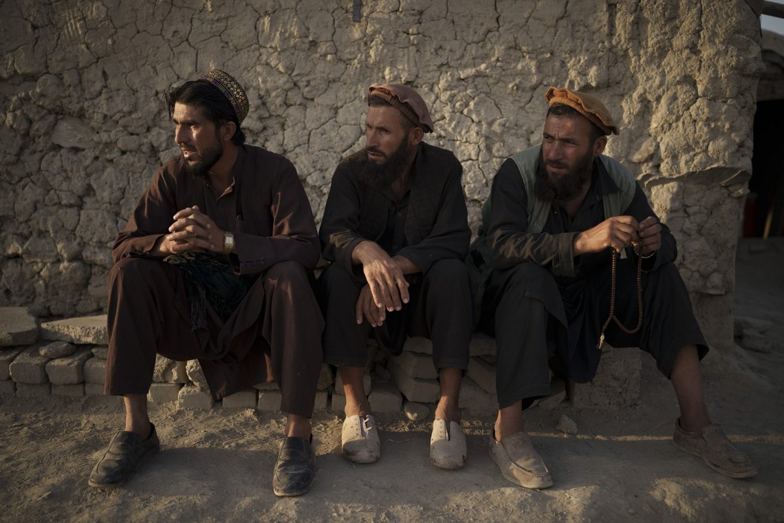 Afghans sit outside a mosque in a poor neighborhood where hundreds of internally displaced people from the eastern part of the country have been living for years, in Kabul, Afghanistan, Monday, Sept. 27, 2021. (AP Photo/Felipe Dana) Afghans sit outside a mosque in a poor neighborhood where hundreds of internally displaced people from the eastern part of the country have been living for years, in Kabul, Afghanistan, Monday, Sept. 27, 2021. (AP Photo/Felipe Dana)