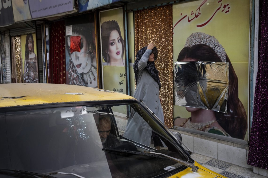 A woman walks past beauty salons with window decorations which have been defaced in Kabul, Afghanistan, Sunday, Sept. 12, 2021. Since the Taliban gained control of Kabul, several images depicting women outside beauty salons have been removed or covered up. (AP Photo/Bernat Armangue) A woman walks past beauty salons with window decorations which have been defaced in Kabul, Afghanistan, Sunday, Sept. 12, 2021. Since the Taliban gained control of Kabul, several images depicting women outside beauty salons have been removed or covered up. (AP Photo/Bernat Armangue)