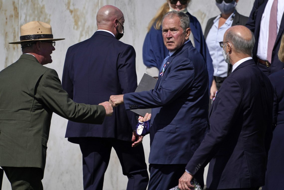 Former President George W. Bush, right center, bumps fists with Flight 93 National Memorial superintendent Stephen M. Clark, left, after participating in a Service of Remembrance at the Flight 93 National Memorial in Shanksville, Pa., Saturday, Sept. 11, 2021, as the nation marks the 20th anniversary of the Sept. 11, 2001 attacks. (AP Photo/Gene J. Puskar) Former President George W. Bush, right center, bumps fists with Flight 93 National Memorial superintendent Stephen M. Clark, left, after participating in a Service of Remembrance at the Flight 93 National Memorial in Shanksville, Pa., Saturday, Sept. 11, 2021, as the nation marks the 20th anniversary of the Sept. 11, 2001 attacks. (AP Photo/Gene J. Puskar)