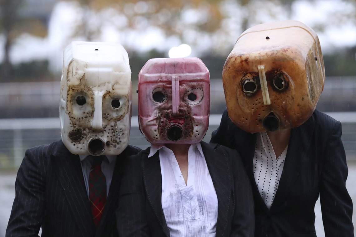 Activists wear oil canister masks after spilling fake oil during their performance near the venue where the U.N. climate conference will be held in Glasgow, Scotland, Friday, Oct. 29, 2021. The U.N. climate conference COP26 starts Sunday in Glasgow. (AP Photo/Scott Heppell) Activists wear oil canister masks after spilling fake oil during their performance near the venue where the U.N. climate conference will be held in Glasgow, Scotland, Friday, Oct. 29, 2021. The U.N. climate conference COP26 starts Sunday in Glasgow. (AP Photo/Scott Heppell)