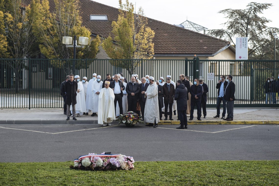 Imams from the Grand Mosque of Paris pay tribute in front of the school where teacher Samuel Paty worked, in Conflans Sainte Honorine, Friday, Oct.15, 2021. French schools are paying tribute to a teacher beheaded by a radical Islamist last year after he showed caricatures of the prophet of Islam to his class. Samuel Paty, a history and geography teacher, was murdered on Oct. 16 last year near his school in a northwest Paris suburb by an 18-year-old of Chechen origin who had become radicalized. (AP Photo/Lewis Joly) Imams from the Grand Mosque of Paris pay tribute in front of the school where teacher Samuel Paty worked, in Conflans Sainte Honorine, Friday, Oct.15, 2021. French schools are paying tribute to a teacher beheaded by a radical Islamist last year after he showed caricatures of the prophet of Islam to his class. Samuel Paty, a history and geography teacher, was murdered on Oct. 16 last year near his school in a northwest Paris suburb by an 18-year-old of Chechen origin who had become radicalized. (AP Photo/Lewis Joly)