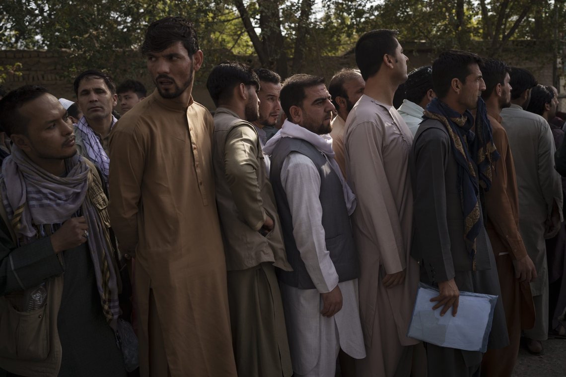 Afghans line up outside a government passport office recently re-opened after Taliban announced they would be issuing a backlog of applications approved by the previous administration in Kabul, Afghanistan, Wednesday, Oct. 6, 2021. (AP Photo/Felipe Dana) Afghans line up outside a government passport office recently re-opened after Taliban announced they would be issuing a backlog of applications approved by the previous administration in Kabul, Afghanistan, Wednesday, Oct. 6, 2021. (AP Photo/Felipe Dana)