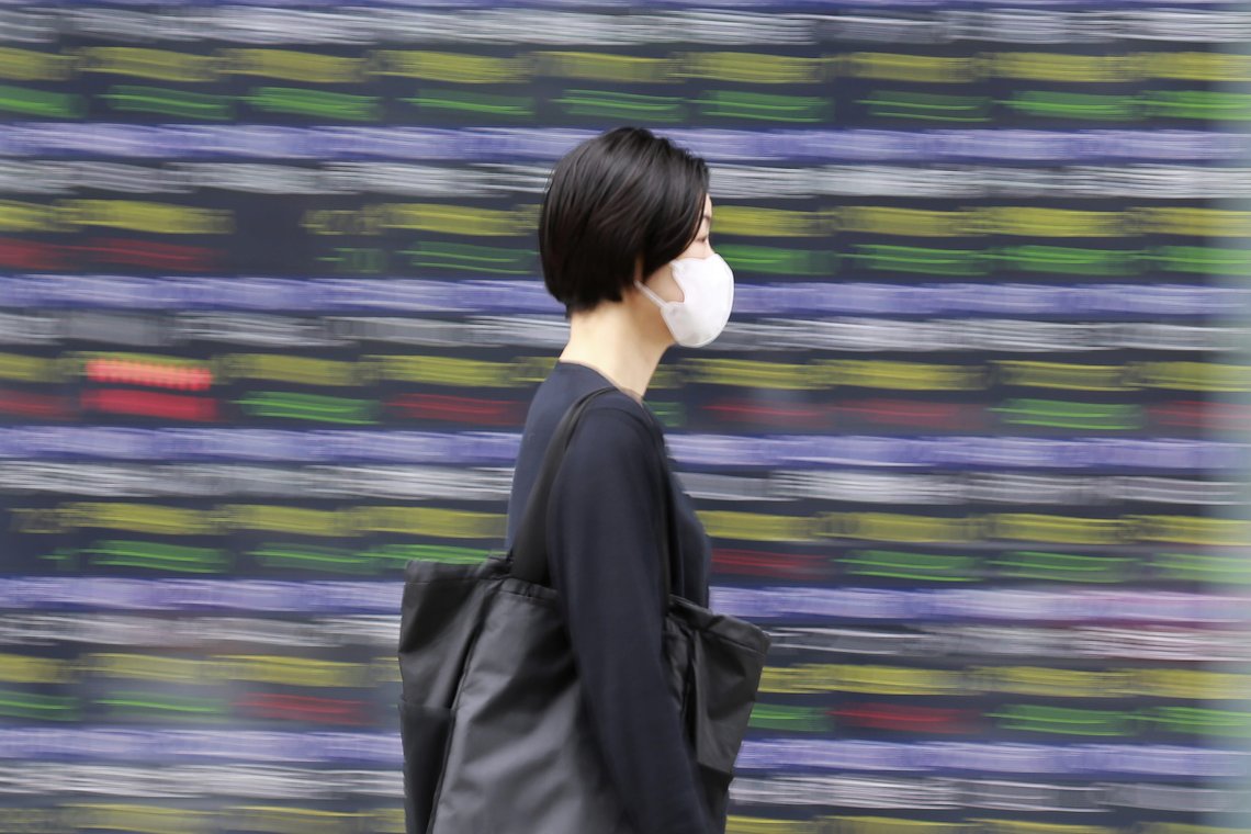 A woman walks by an electronic stock board of a securities firm in Tokyo, Monday, Nov. 22, 2021. Stocks were mixed in Asia on Monday after ending the week mostly lower on Wall Street, despite the Nasdaq's first close above 16,000. (AP Photo/Koji Sasahara) A woman walks by an electronic stock board of a securities firm in Tokyo, Monday, Nov. 22, 2021. Stocks were mixed in Asia on Monday after ending the week mostly lower on Wall Street, despite the Nasdaq's first close above 16,000. (AP Photo/Koji Sasahara)
