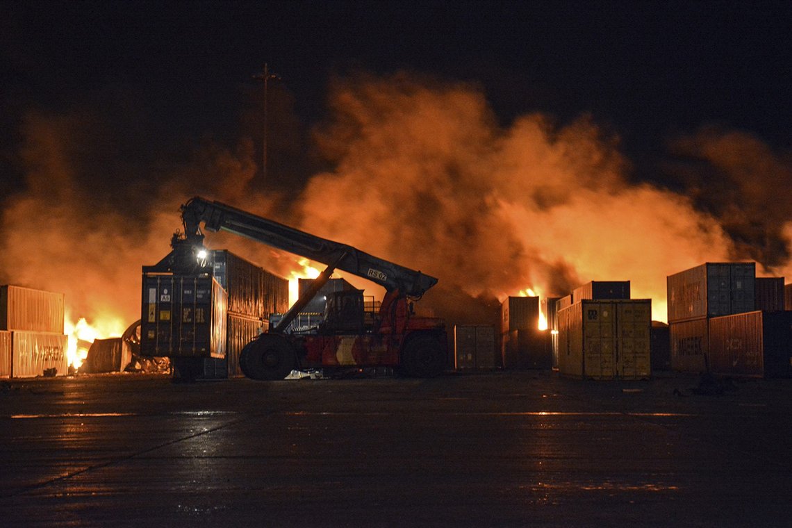 In this photo released by the Syrian official news agency SANA, flames rise from burning containers at the scene of a missile attack, at the seaport of the coastal city of Latakia, Syria, early Tuesday, Dec. 28, 2021. Israeli missiles fired from the Mediterranean struck the Syrian port of Latakia early Tuesday, igniting a fire in the container terminal, Syrian state media reported, in the second such attack on the vital facility this month. (SANA via AP) In this photo released by the Syrian official news agency SANA, flames rise from burning containers at the scene of a missile attack, at the seaport of the coastal city of Latakia, Syria, early Tuesday, Dec. 28, 2021. Israeli missiles fired from the Mediterranean struck the Syrian port of Latakia early Tuesday, igniting a fire in the container terminal, Syrian state media reported, in the second such attack on the vital facility this month. (SANA via AP)