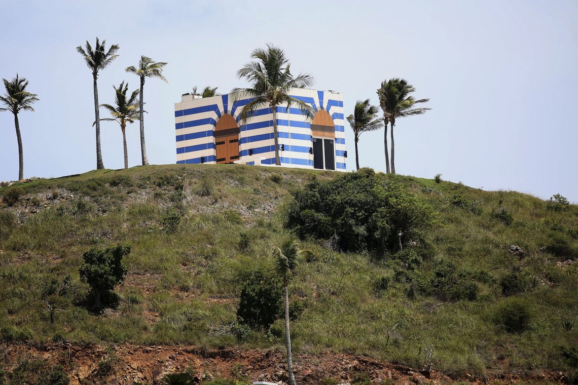 A blue-striped structure sits on a lookout point on Little St. James Island, in the U. S. Virgin Islands, a property owned by Jeffrey Epstein, Wednesday, Aug. 14, 2019. Epstein bought Little St. James Island more than two decades ago and built a stone mansion with cream-colored walls on one end of it. Surrounding it are several other structures including the maidsÄô quarters and the huge, square-shaped, blue-striped building on the other end of the island that workers told each other was a music room fitted with a grand piano and acoustic walls. (AP Photo/Gabriel Lopez Albarran) A blue-striped structure sits on a lookout point on Little St. James Island, in the U. S. Virgin Islands, a property owned by Jeffrey Epstein, Wednesday, Aug. 14, 2019. Epstein bought Little St. James Island more than two decades ago and built a stone mansion with cream-colored walls on one end of it. Surrounding it are several other structures including the maidsÄô quarters and the huge, square-shaped, blue-striped building on the other end of the island that workers told each other was a music room fitted with a grand piano and acoustic walls. (AP Photo/Gabriel Lopez Albarran)