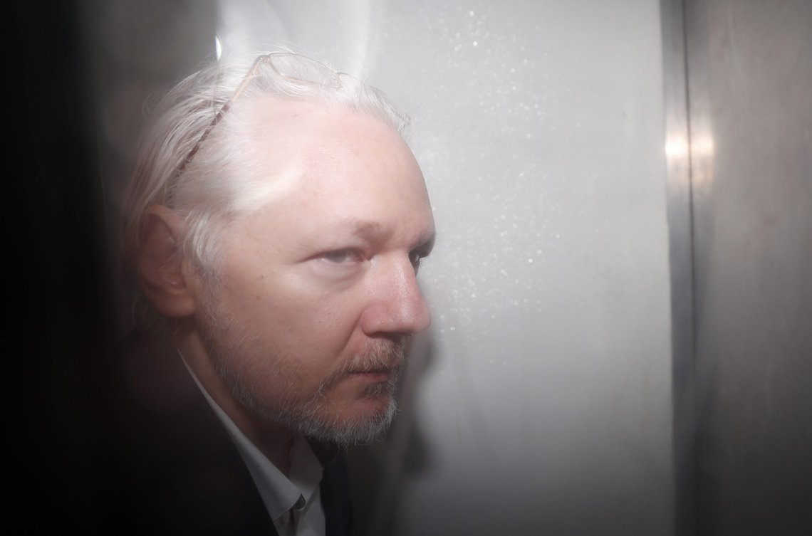 WikiLeaks founder Julian Assange is seen in a prison van traveling to Westminster Magistrates Court in London, Friday, Dec. 20, 2019. Assange is expected to appear in person before Westminster Magistrates in a private hearing related to a Spanish criminal case about alleged surveillance at the Ecuador embassy.(AP Photo/Frank Augstein) WikiLeaks founder Julian Assange is seen in a prison van traveling to Westminster Magistrates Court in London, Friday, Dec. 20, 2019. Assange is expected to appear in person before Westminster Magistrates in a private hearing related to a Spanish criminal case about alleged surveillance at the Ecuador embassy.(AP Photo/Frank Augstein)