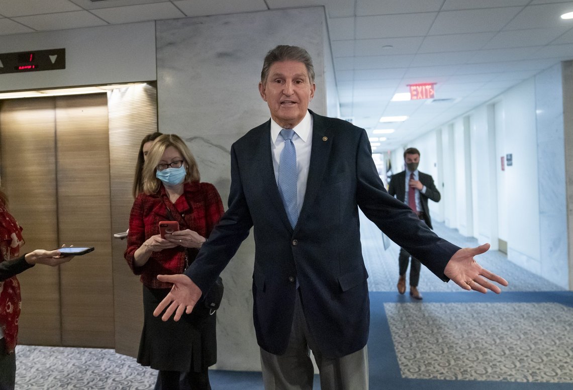 In this Dec. 13, 2021, photo, Sen. Joe Manchin, D-W.Va., leaves his office after speaking with President Joe Biden about his long-stalled domestic agenda, at the Capitol in Washington. Manchin’s reluctance to endorse the Biden administration’s expanded child tax credit program is rippling through his home state of West Virginia. Manchin, a moderate Democrat, is one of the last holdouts delaying passage of President Joe Biden’s massive social and environmental package. (AP Photo/J. Scott Applewhite) In this Dec. 13, 2021, photo, Sen. Joe Manchin, D-W.Va., leaves his office after speaking with President Joe Biden about his long-stalled domestic agenda, at the Capitol in Washington. Manchin’s reluctance to endorse the Biden administration’s expanded child tax credit program is rippling through his home state of West Virginia. Manchin, a moderate Democrat, is one of the last holdouts delaying passage of President Joe Biden’s massive social and environmental package. (AP Photo/J. Scott Applewhite)