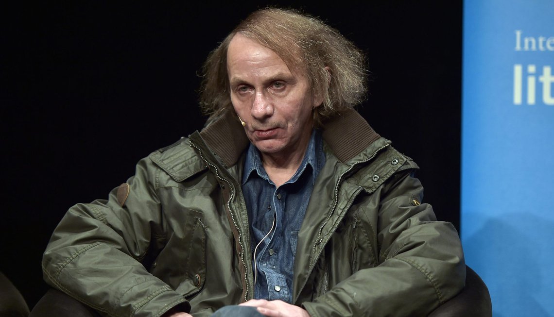 French novelist and poet Michel Houellebecq watches the audience prior to a reading of his latest book in Cologne, Germany, Monday, Jan. 19, 2015. The controversial author appears in public for the first time after his book "Soumission" (submission) was published on the day of the Charlie Hebdo shooting in Paris. A cartoon of Houellebecq was published on the magazine's cover page that day, giving attention to his book, describing a future France where a Muslim president is ruling the country according to Islamic law. (AP Photo/Martin Meissner) French novelist and poet Michel Houellebecq watches the audience prior to a reading of his latest book in Cologne, Germany, Monday, Jan. 19, 2015. The controversial author appears in public for the first time after his book "Soumission" (submission) was published on the day of the Charlie Hebdo shooting in Paris. A cartoon of Houellebecq was published on the magazine's cover page that day, giving attention to his book, describing a future France where a Muslim president is ruling the country according to Islamic law. (AP Photo/Martin Meissner)