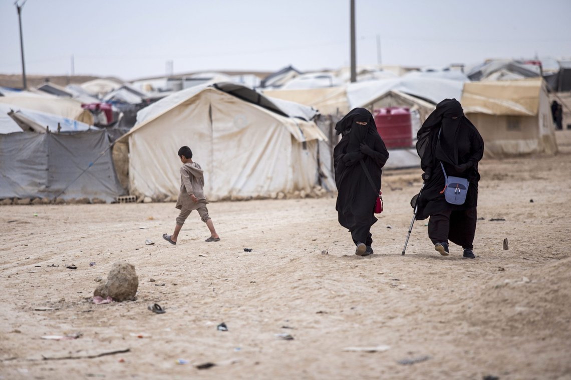 FILE - In this May 1, 2021 file photo, women walk in the al-Hol camp that houses some 60,000 refugees, including families and supporters of the Islamic State group, many of them foreign nationals, in Hasakeh province, Syria. Nearly a dozen buses carrying 100 Iraqi families who lived in a sprawling camp in Syria for supporters and families of Islamic State militants returned to Iraq on Tuesday, May 25, where public opinion is divided about their return. (AP Photo/Baderkhan Ahmad, File) FILE - In this May 1, 2021 file photo, women walk in the al-Hol camp that houses some 60,000 refugees, including families and supporters of the Islamic State group, many of them foreign nationals, in Hasakeh province, Syria. Nearly a dozen buses carrying 100 Iraqi families who lived in a sprawling camp in Syria for supporters and families of Islamic State militants returned to Iraq on Tuesday, May 25, where public opinion is divided about their return. (AP Photo/Baderkhan Ahmad, File)